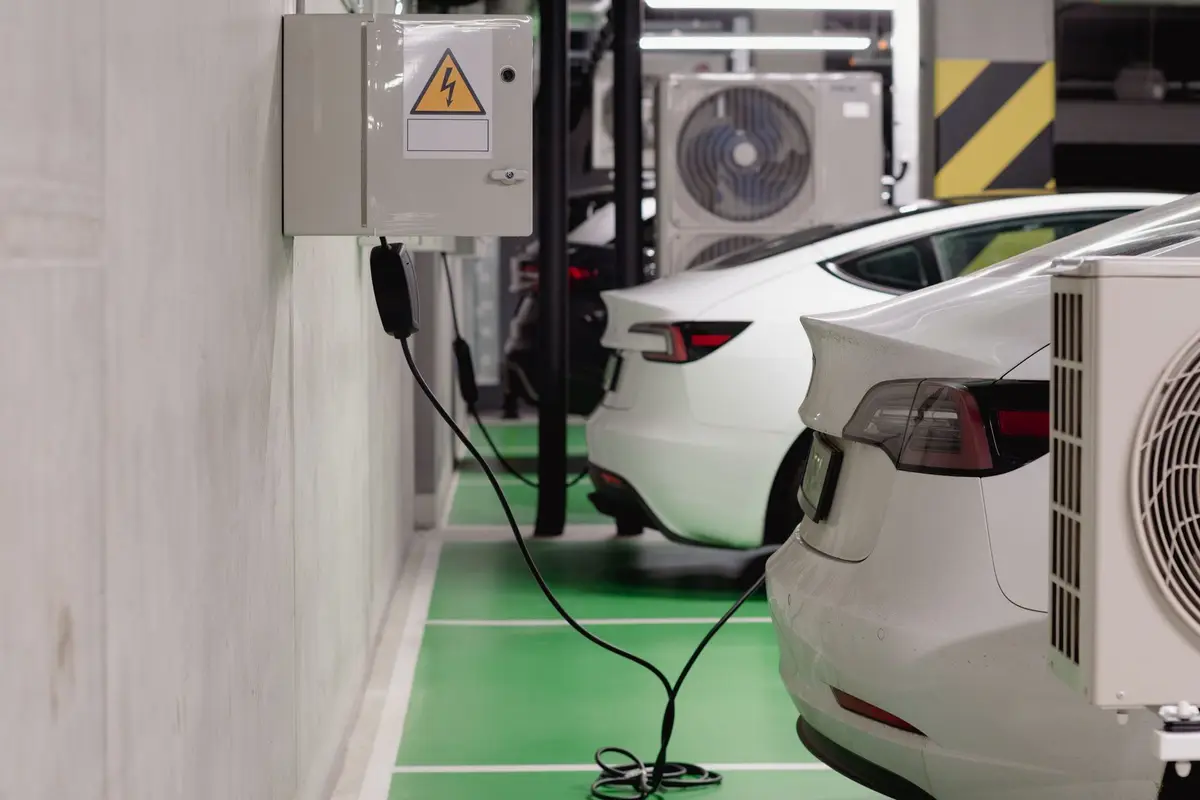 地下停車場內電動車停在充電設備旁，呈現社區加裝充電樁的用電場景