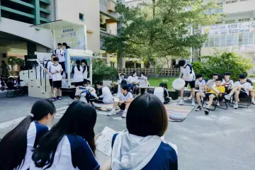 國家人權博物館人權故事車停在竹山高中校園，校舍位於車輛後方。