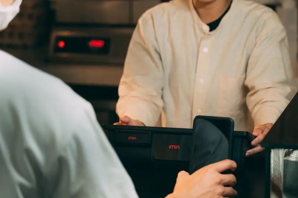 手持 Android 手機準備感應付款，象徵 Samsung Wallet 綁卡與驗證流程
