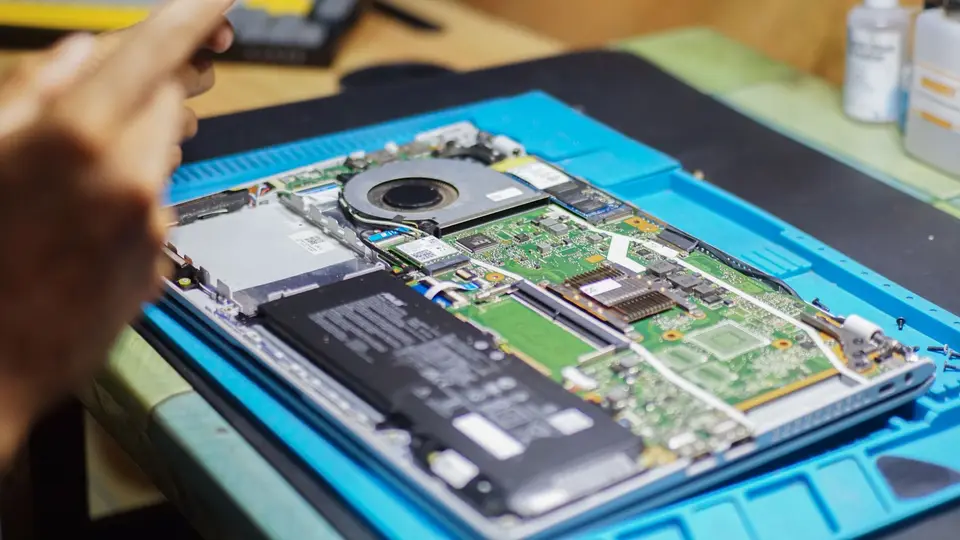 筆電升級 RAM 前要先查機型、插槽與保固 筆記型電腦拆開放在維修桌上檢查內部零件